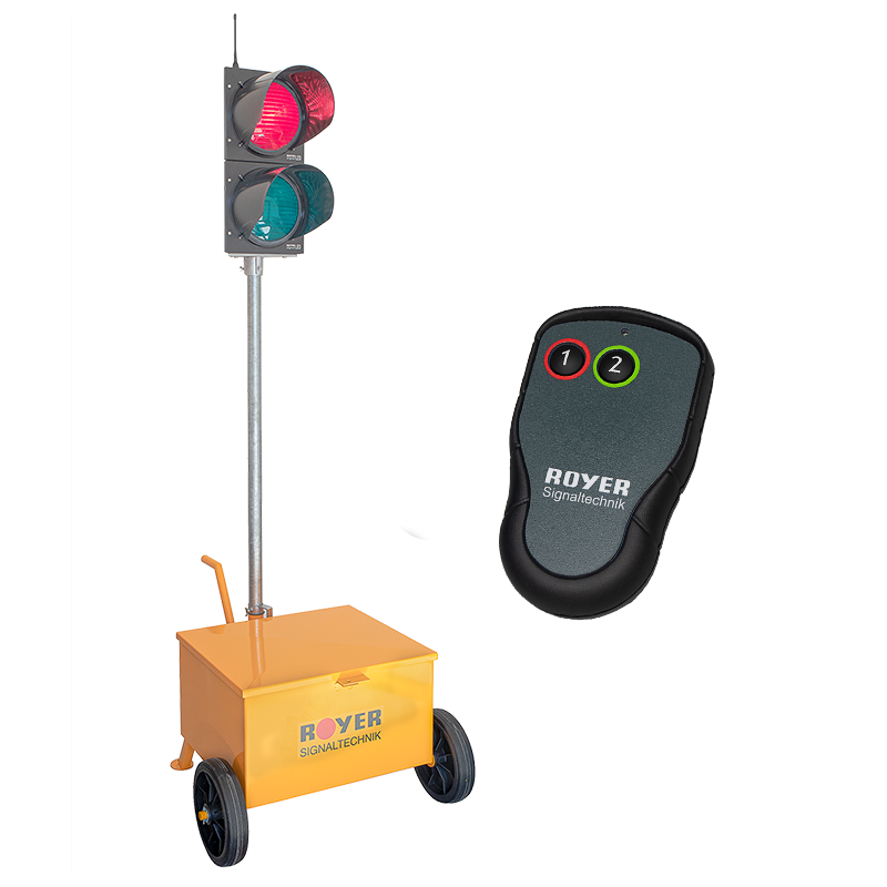 Eine mobile Ampelanlage mit gelbem Batteriewagen und Ampel mit Rotlicht und Grünlicht, dazu ein Handsender zur manuellen Bedienung.
